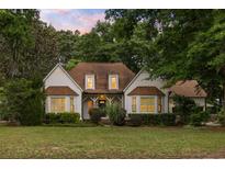 Charming home featuring a well-manicured lawn and mature trees, providing a welcoming curb appeal at 1019 Royalist Rd, Mount Pleasant, SC 29464