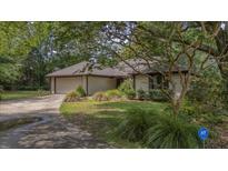 Charming single-story home with a well-manicured lawn, mature trees, and a convenient attached two-car garage at 1129 Belvedere Ter, Mount Pleasant, SC 29464