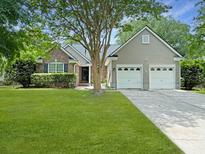 Charming single Gathering home featuring a brick facade, a two car garage, and a lush green lawn at 1317 Wild Olive Dr, Mount Pleasant, SC 29464