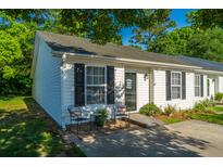 Charming townhouse with tidy landscaping and a cozy patio area with seating at 1327 Pinnacle Ln, Charleston, SC 29412