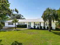 Beautifully landscaped single-story home with a well manicured lawn and elegant walkway at 1467 Battalion Dr, James Island, SC 29412