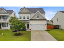 Charming two-story home with a well-manicured lawn and a two-car garage at 192 Weeping Cypress Dr, Moncks Corner, SC 29461