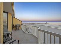 Lovely balcony with seating and beautiful ocean view perfect for relaxing and enjoying the sunrise at 201 W Arctic Ave # 406, Folly Beach, SC 29439