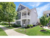 Charming two-story home featuring a double balcony and beautifully landscaped front yard at 2025 Maybelles Ln, Charleston, SC 29414