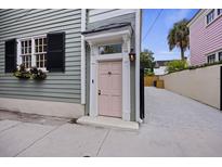 Charming home featuring a pink front door with a window box and driveway at 29 Bogard St, Charleston, SC 29403