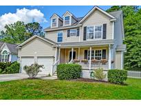Charming two-story home features a welcoming front porch and well-maintained landscaping at 3073 Penny Ln, Johns Island, SC 29455