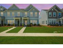 Charming townhome with gray siding, well-manicured lawn and sidewalks leading to covered entryway at 326 Surfbird Rd # 388, Summerville, SC 29486