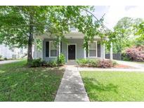 Charming home with mature trees, a sidewalk to front door, and manicured lawn at 4818 Holly Berry Ln, Summerville, SC 29485
