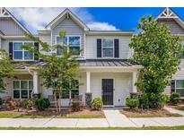 Charming two-story townhouse with well-maintained landscaping and inviting front porch at 502 Duskywing Dr, Goose Creek, SC 29445