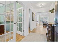 Bright foyer with hardwood floors leading to a study with French doors and an open-concept living area at 101 Caleb Ct, Ladson, SC 29456