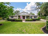 Charming brick home with well-manicured lawn and mature landscaping, offering great curb appeal at 102 Ashborough Ave, Summerville, SC 29485