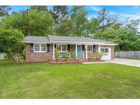 Charming brick home with a well-manicured lawn and a welcoming light blue front door at 105 Bermuda Ct, Summerville, SC 29485