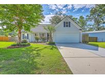 Charming single-Gathering home features a well-manicured lawn, a two-car garage, and beautiful landscaping at 110 Salinas Ct, Summerville, SC 29483