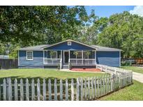Charming blue home with a white picket fence and front porch at 116 Cone Ln, Summerville, SC 29483