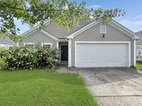 Charming one-story home with a well-manicured lawn and a two car garage at 120 Larkspur Dr, Goose Creek, SC 29445