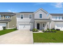 Charming two-story home with a well-manicured lawn and attached garage at 130 Spotted Way, Summerville, SC 29485