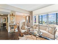 Bright living room features stylish seating, glass tables, and stunning views of the water at 14 Lockwood Dr # 4C, Charleston, SC 29401