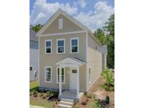 Charming two-story home featuring a covered porch and a well-manicured front lawn at 1671 Indy Dr, North Charleston, SC 29405