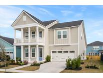 Charming two-story home with a welcoming front porch, manicured landscaping, and an attached two-car garage at 190 Steepbrook Dr, Summerville, SC 29486