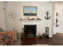 Living room with nautical decor, fireplace, and decorative compass over the mantle at 1928 Chatelain Way, Mount Pleasant, SC 29464