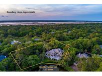 Expansive estate on a 1.23 acre double corner lot surrounded by lush greenery and waterfront at 200 Belted Kingfisher Rd, Kiawah Island, SC 29455