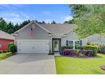 Charming home featuring a well-maintained yard, attached two-car garage and a covered front entryway at 2008 Welsh Pony Dr, Mount Pleasant, SC 29429