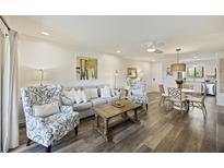 Bright living room featuring stylish seating, wood floors, and an open floorplan connected to the dining area at 2063 Long Bend Dr, Seabrook Island, SC 29455