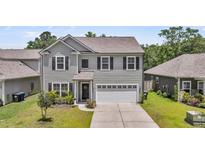 Charming two-story home featuring a two-car garage, well-maintained lawn, and attractive landscaping at 2109 Rowan Rd, Johns Island, SC 29455
