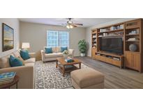 Inviting living room features stylish furniture, area rug, and a built-in entertainment center with bookshelves at 2150 Spoleto Ln # H2, North Charleston, SC 29406