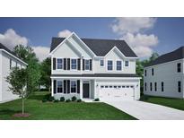 Charming two-story home featuring a covered entryway, attached two-car garage, and manicured lawn at 2476 Grange Cir, Summerville, SC 29486