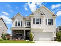 Charming two-story home features a welcoming front porch, attached garage, and classic curb appeal at 2746 Sunrose Ln, Johns Island, SC 29455