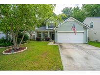Charming two-story home with well-manicured lawn, two-car garage and American flag at 3031 Ellington Dr, Summerville, SC 29485