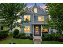 Charming two-story home with blue siding, white trim, and lush landscaping, showcasing curb appeal at 410 Eliston St, Summerville, SC 29486