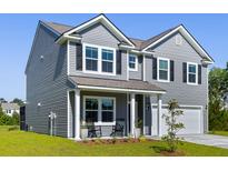 Charming two-story home with gray siding, black shutters, and a well-manicured front lawn at 5115 Cranesbill Way, Johns Island, SC 29455
