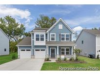 Charming two-story home with a two-car garage and beautifully landscaped front yard at 714 N Hickory St # 13, Summerville, SC 29483