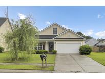 Charming single-story home with a manicured lawn and a two-car garage in a suburban neighborhood at 108 Larkspur Dr, Goose Creek, SC 29445