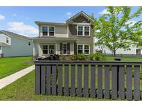 Charming two-story home with a combination of siding and shingles and a picket fence surrounding the yard at 113 Petrell Rd, Summerville, SC 29483