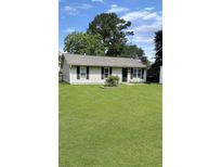 Charming single-story home with a well-manicured lawn and classic curb appeal at 1207 Saint Johns Ave, Moncks Corner, SC 29461