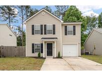Charming two-story home features a classic design with black shutters and a well-maintained front yard at 1219 Bradley Blvd, Summerville, SC 29486