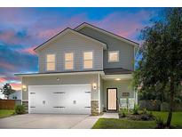 Two-story home featuring attached garage, manicured lawn, landscaping, and charming front porch with seating at 160 Brookhaven Rd, Summerville, SC 29486