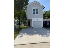 Modern two-story home with gray siding, a well-kept lawn, and a concrete driveway leading to an attached garage at 1991 Joppa Ave, North Charleston, SC 29405