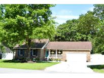Charming single-story brick home with manicured lawn and lush greenery, a lovely exterior at 2233 Glendale Dr, Charleston, SC 29414