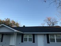 Charming home with a new black roof, light gray siding, black shutters and white doors at 2317 Elegans Drive Dr, North Charleston, SC 29405