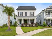 Charming two-story home with a welcoming front porch, landscaped yard, and beautiful curb appeal at 2747 Calico Bass Ln, Johns Island, SC 29455