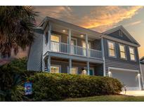 Charming two-story home with a double porch and a manicured lawn at 346 Cicadas Song, Moncks Corner, SC 29461