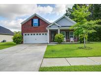Charming two-story home with a brick facade, well-manicured lawn, and a spacious two-car garage at 3639 Pimmit Pl, Ladson, SC 29456