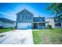 Charming two-story home with a well-manicured lawn and inviting front porch at 414 Dovetail Cir, Summerville, SC 29483