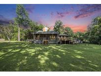Spacious front yard with a charming single-Gathering home and inviting front porch at 417 Dennis Ave, Moncks Corner, SC 29461