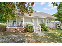 Charming single-story home with a welcoming front porch, well-maintained landscaping, and neutral-toned exterior at 617 Willdrew Ln, Moncks Corner, SC 29461