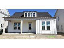 Charming single-story home with a covered porch, white siding, and a dormer window at 827 Gentle Breeze Dr, Summerville, SC 29486